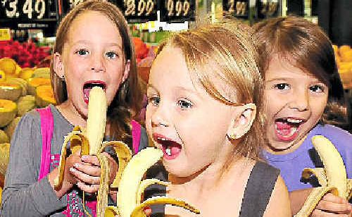 Jorja Annetts, 5, (left) and her cousins Abigail, 3, and Amelia Robb, 4, enjoy a banana from the Fruit Shed in Warana with the news banana prices are set to drop. Jorja Annetts, 5, (left) and her cousins Abigail, 3, and Amelia Robb, 4, enjoy a banana from the Fruit Shed in Warana with the news banana prices are set to drop.